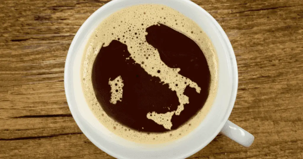 A cup of coffee, with the crema shaped like Italy