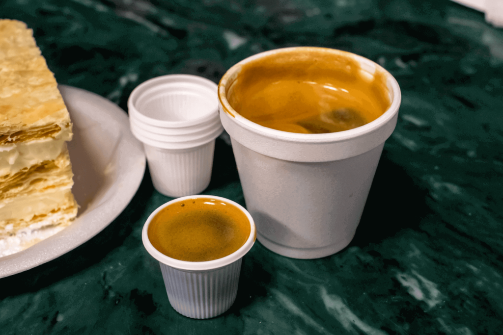 A colado, showing the large portion of cafe cubano and the separate cups for sharing