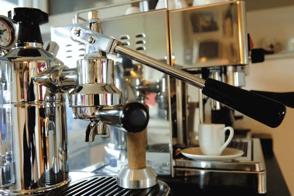 A manual espresso machine, showing the lever used to operate it