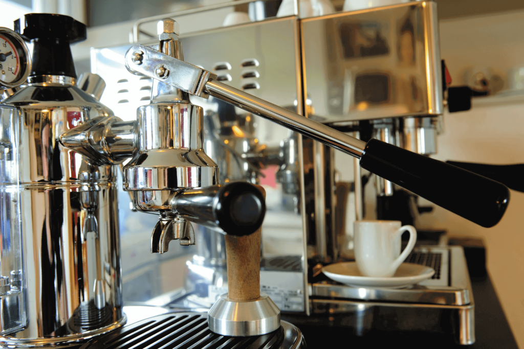 A manual espresso machine, showing the lever used to operate it