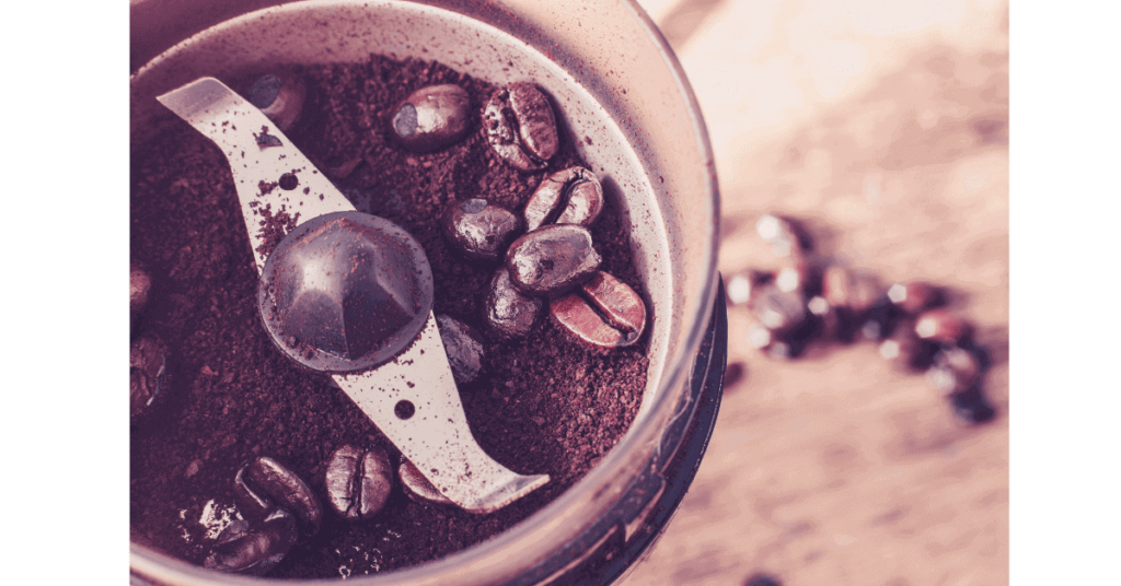 A closeup of coffee beans in a blade coffee grinder