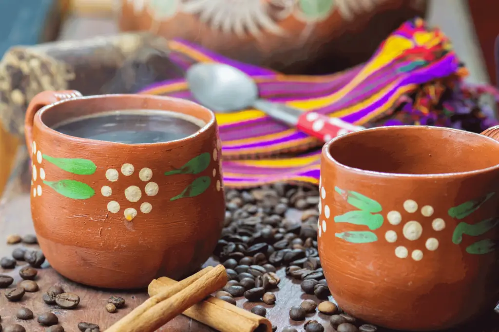 Cafe de olla, a traditional Mexican coffee drink served in a clay pot