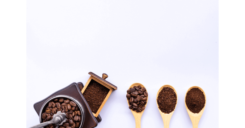 A coffee grinder beside three different coffee ground sizes