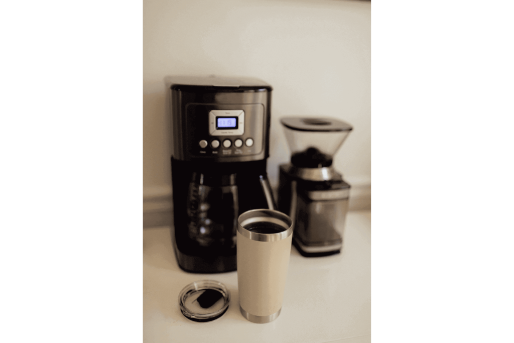 A coffee machine and coffee grinder, both of which could be replaced with a coffee maker with grinder built-in.