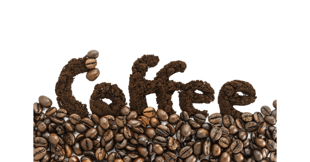 The word coffee written in coffee grounds against a background of coffee beans