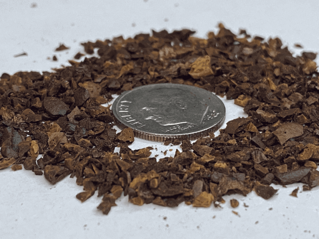 Extra coarse grind coffee, with a dime for size comparison