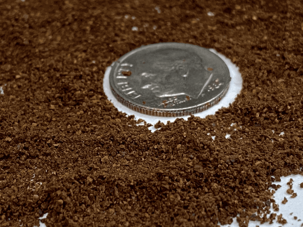 Fine grind coffee, with a dime for size comparison