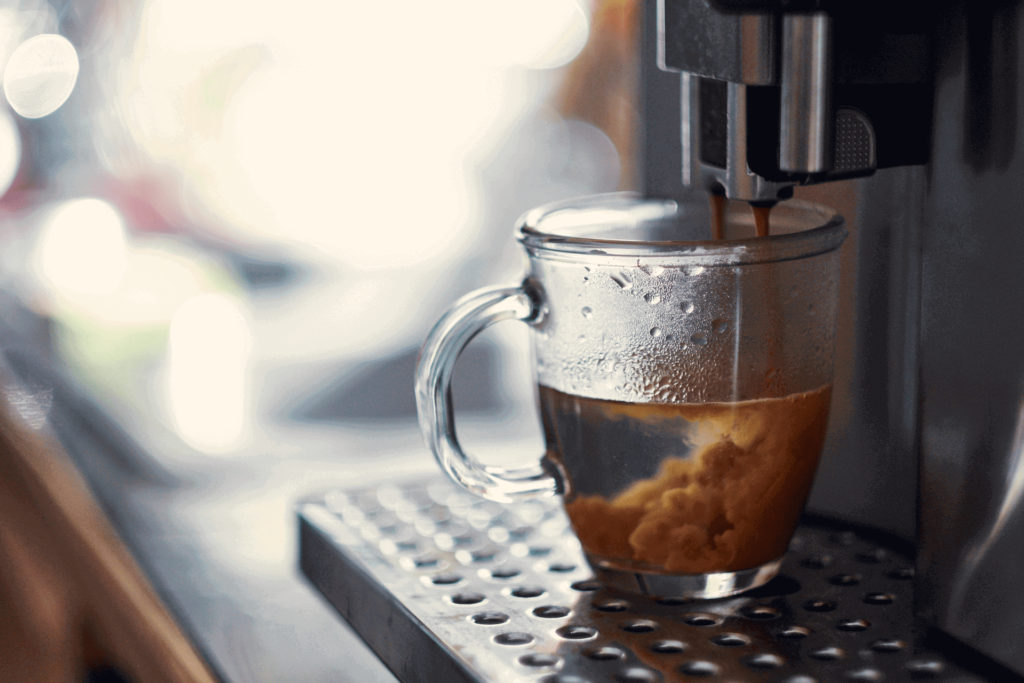 Espresso dropping into hot water to make a long black coffee