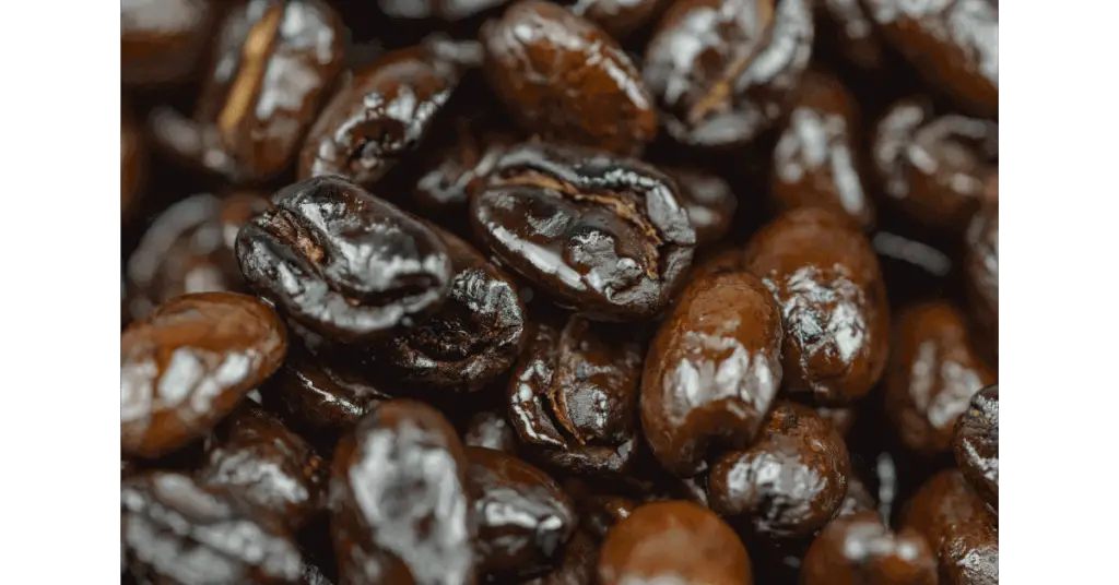 A closeup of oily coffee beans, showing how shiny they can be