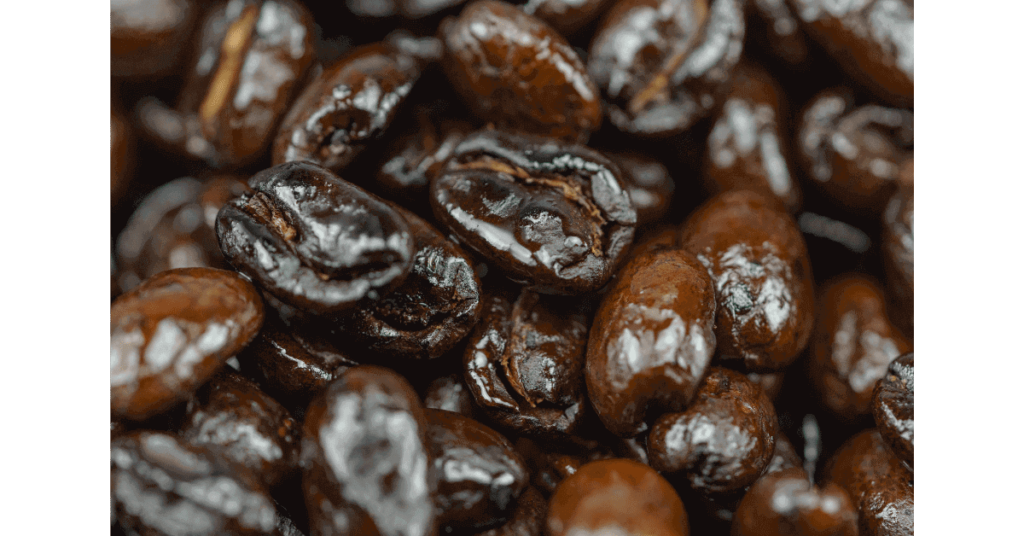 A closeup of oily coffee beans, showing how shiny they can be