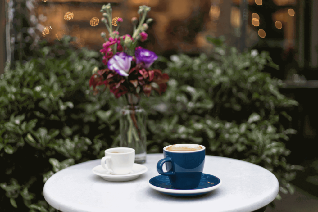 An Americano coffee and a shot of espresso, showing the size difference