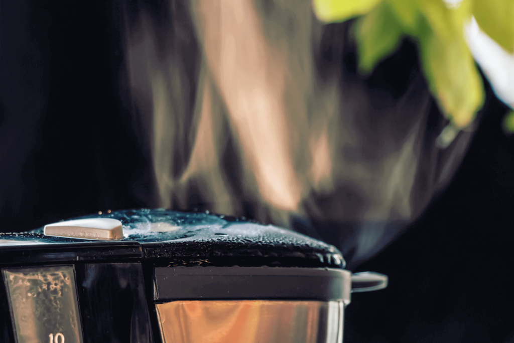 Steam rising from hot water in a coffee maker