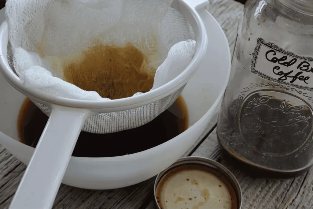 Straining coffee grounds, a step in making cold brew