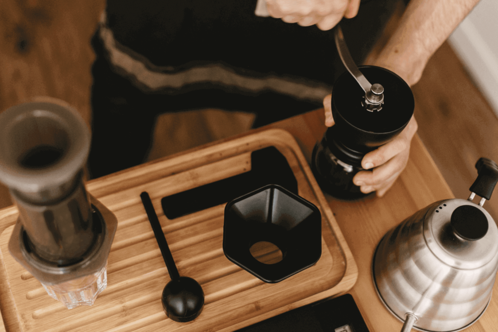 Using a manual coffee grinder to grind beans for your AeroPress