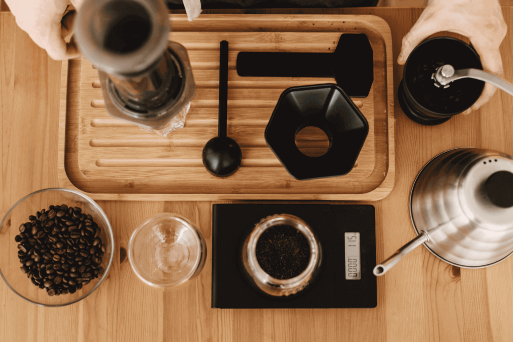 An AeroPress coffee maker setup, including grinder and coffee scale