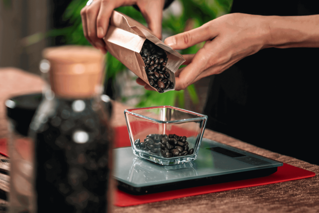 Pouring beans onto a coffee scale to weigh them