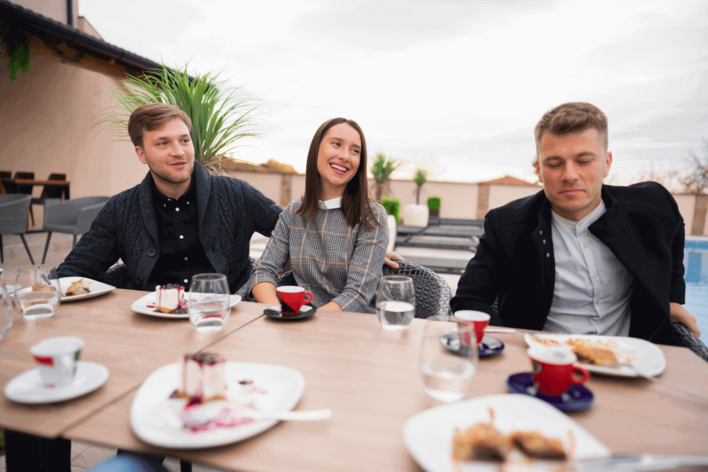 A table of people drinking coffee and espresso after a meal