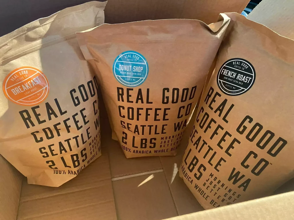 Three different Real Good Coffee Company blends being unboxed